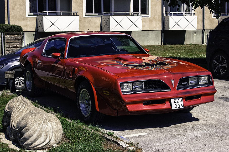 Red 1977 Pontiac Firebird Trans Am with hood bird decal