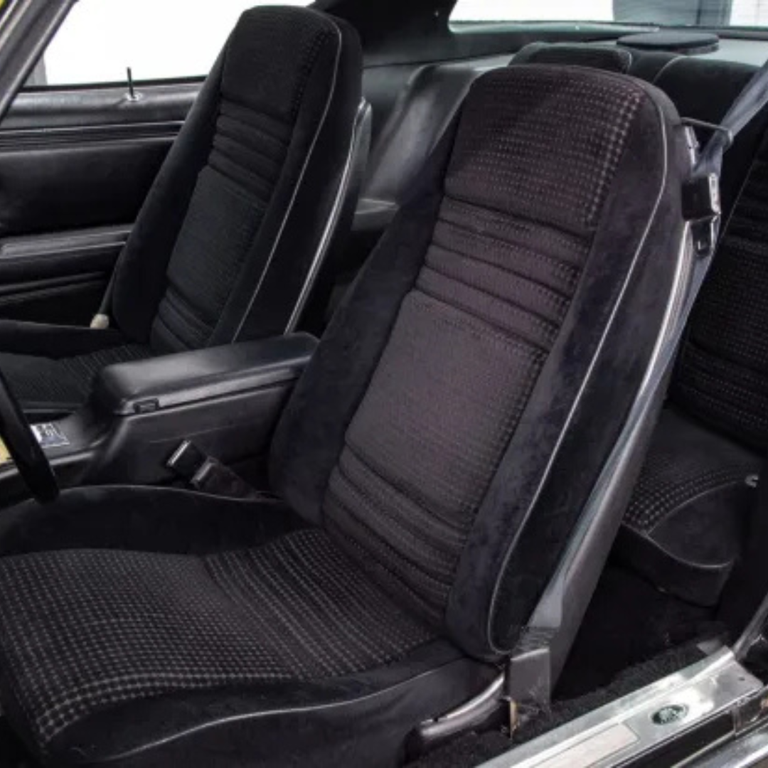 Second-generation Trans Am interior with black houndstooth cloth bucket seats, console and door panel